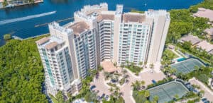 An aerial view of a condominium building in the highland beach area close to the water